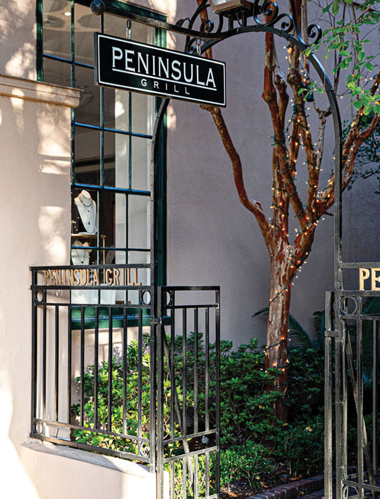 The entrance to the courtyard at Peninsula Grill, with signs