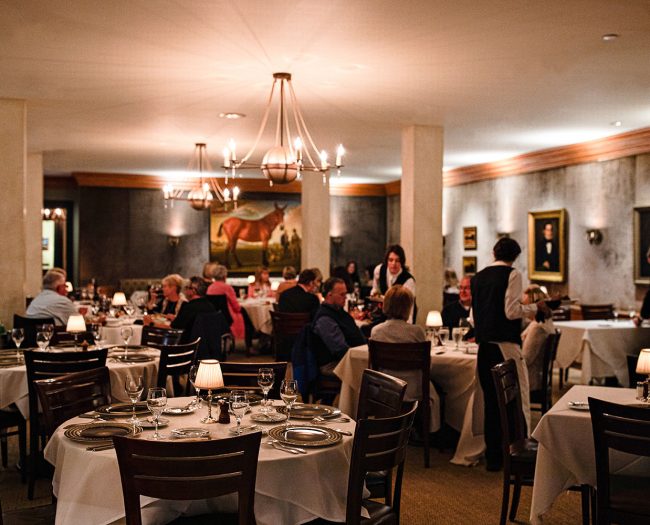 Customers enjoying dinner at Peninsula Grill in the dining room